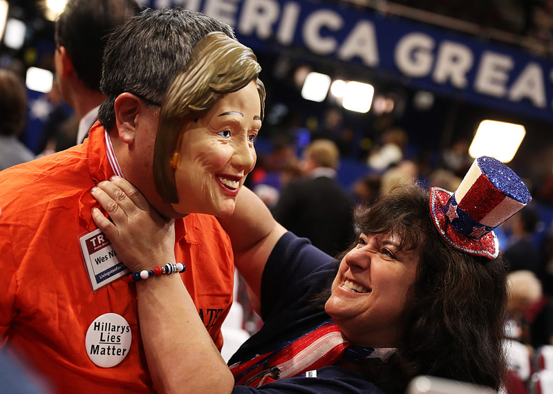 A delegate mock-strangles a man wearing a Hillary Clinton mask at the Republican National Convention (Photo by Joe Raedle/Getty Images)